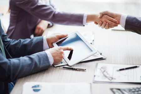 Business people pointing at ipad